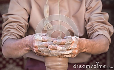 Potter making a piece of clay into a pottery piece Stock Photo