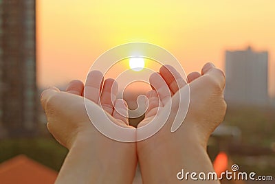 Hands open to the morning sky with the rising sun Stock Photo
