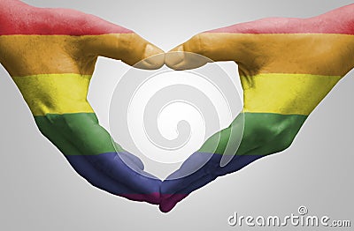 Hands painted as the rainbow flag forming a heart Stock Photo