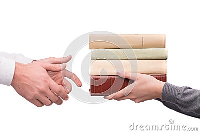 Hands passing heap of books Stock Photo