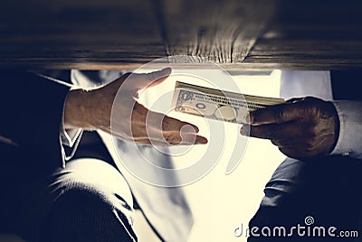 Hands passing money under table corruption bribery Stock Photo