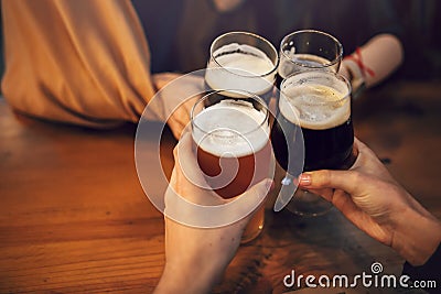 Hands of people holding beer and cheering in brewery pub. people Stock Photo