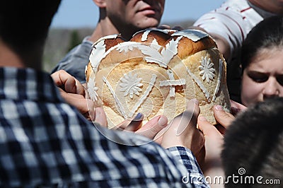 Hands of people touching decorated bread, celebration of Orthodox Easter Editorial Stock Photo