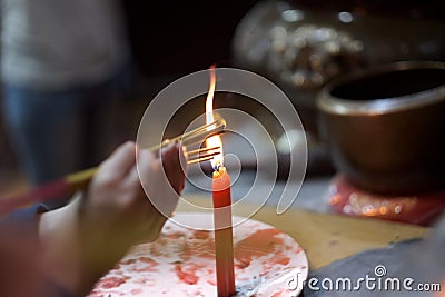 Hands of a person with a bunch of thin candles Stock Photo