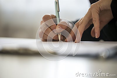 Hands of a person writing on a notepad Stock Photo