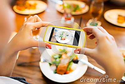 Hands photographing food by smartphone Stock Photo