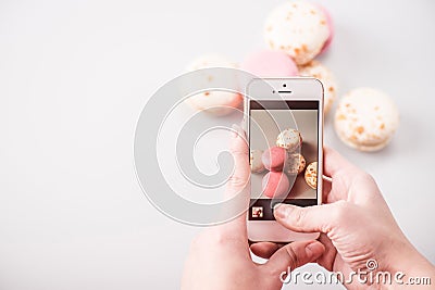 Hands photographing macarons Stock Photo