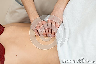 Hands of physiotherapist checking diastasis recti on belly of postpartum woman Stock Photo
