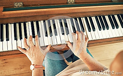 Hands, piano and senior woman playing for music in living room for musical entertainment practice. Instrument, hobby and Stock Photo