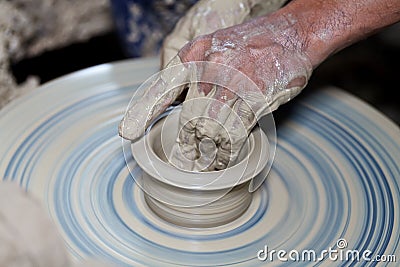 Hands on a piece of pottery made of clay Stock Photo