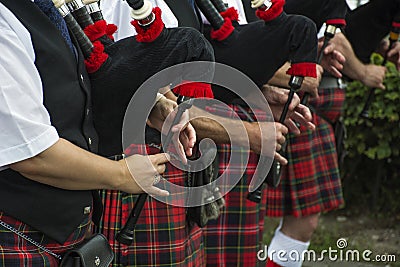 Hands play the bagpipes Stock Photo