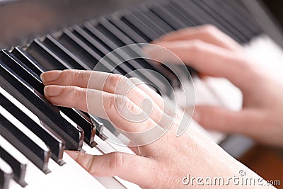 Hands playing music on the piano Stock Photo