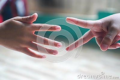 hands playing rock paper scissors game. Rock paper scissors game process. Stock Photo
