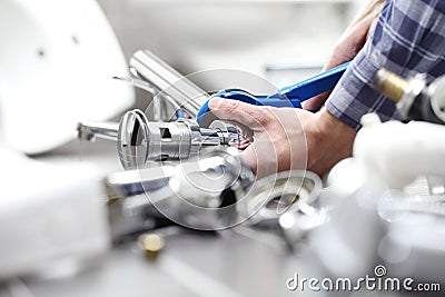 Hands plumber at work in a bathroom, plumbing repair service, as Stock Photo