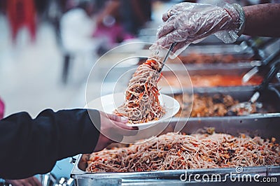 The hands of the poor have been begging to donate food from the donor, The concept of feeding Stock Photo