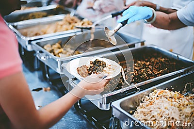 The hands of the poor have been begging to donate food from the donor, The concept of feeding Stock Photo