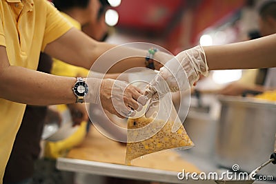 The hands of the poor receive food from the hands of the humane : the concept of relief Stock Photo