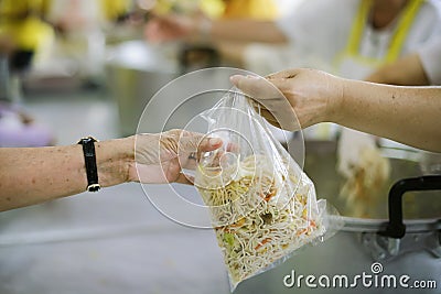 The hands of the poor receive food from the hands of the humane : the concept of relief Stock Photo