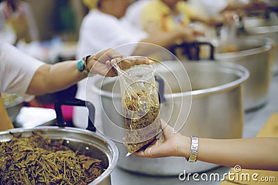 The hands of the poor receive food from the hands of the humane : the concept of relief Stock Photo