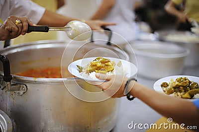 The hands of the poor receive food from the hands of the humane : the concept of relief Stock Photo