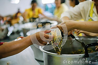 The hands of the poor receive food from the hands of the humane : the concept of relief Stock Photo