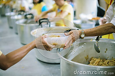 The hands of the poor receive food from the hands of the philanthropist : concept of giving Stock Photo