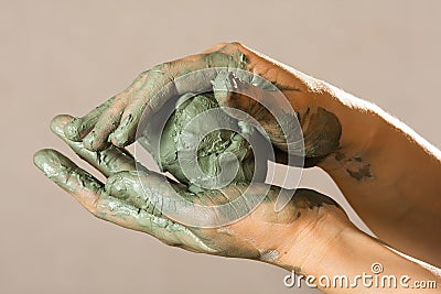 Hands of a potter with blue clay Stock Photo