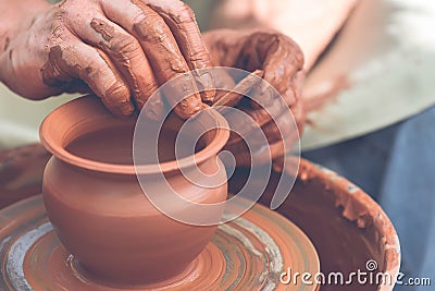 Potter making ceramic pot on the pottery wheel Stock Photo