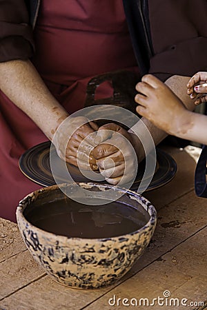 Hands of a potter forming clay Stock Photo