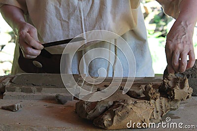 Hands of a potterHands of a potter, creating clay tile. Editorial Stock Photo