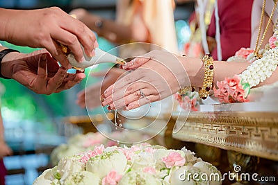 Hands pouring blessing water into bride`s bands, Thai wedding. Stock Photo