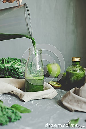 Hands pouring healthy green smoothie in a jar. Healthy eating concept Stock Photo