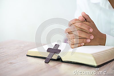 Hands praying on a Holy Bible, spirtuality and religion, Religious concepts Stock Photo