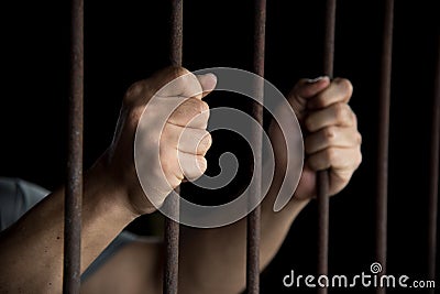 Hands of the prisoner in jail Stock Photo