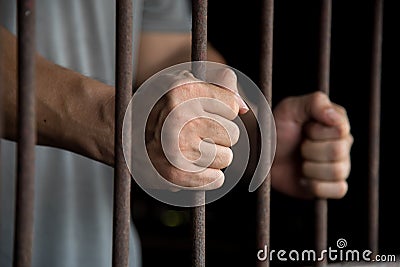 Hands of the prisoner in jail Stock Photo