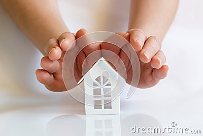 Hands protect house . Stock Photo