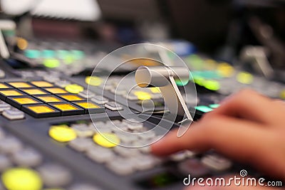 Hands push a button of Switcher buttons in studio TV station, Au Stock Photo