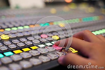 Hands push a button of Switcher buttons in studio TV station, Au Stock Photo
