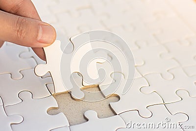 Hands put puzzle pieces last jigsaw puzzle, business concept for Stock Photo