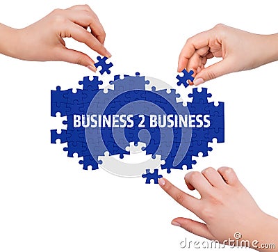 Hands with puzzle making BUSINESS 2 BUSINESS word Stock Photo