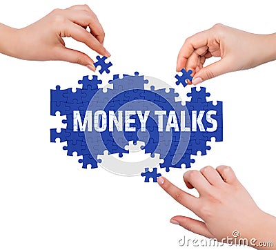 Hands with puzzle making MONEY TALKS word Stock Photo
