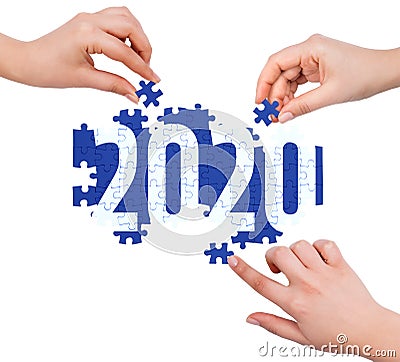 Hands with puzzle making 2020 word Stock Photo
