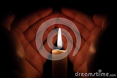 Hands raised for prayer Muslim supplication candle light Stock Photo