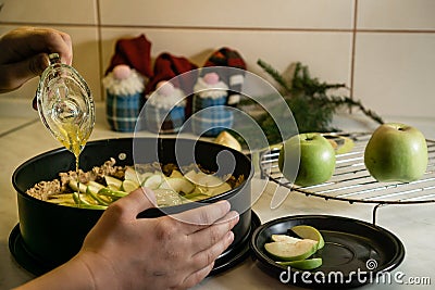 Hands and raw apple pie with hany on table with towel and knife Stock Photo