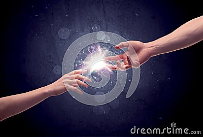 Hands reaching to light a spark Stock Photo