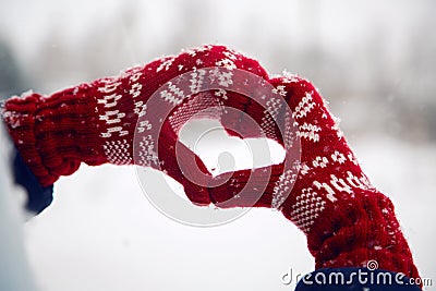 Hands in red mittens folded heart Stock Photo