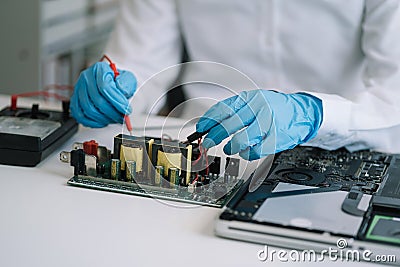 Hands repairing electronic devices. Electronic technician Stock Photo