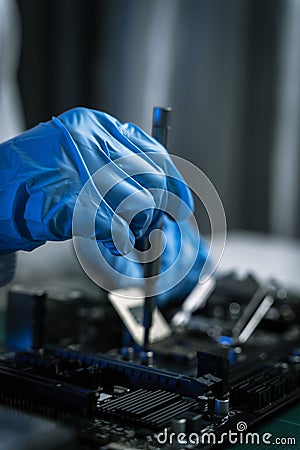 Hands repairing electronic devices. Electronic technician Stock Photo