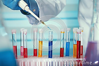 Hands of a researcher pipetting liquid samples in tubes test Stock Photo