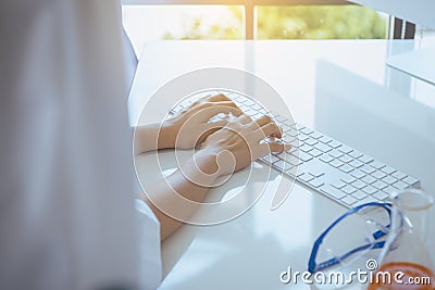 Hands researcher woman using computer keyboard on desk in office room,Fingers typing close up Stock Photo